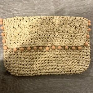 Straw clutch with pom pom trim